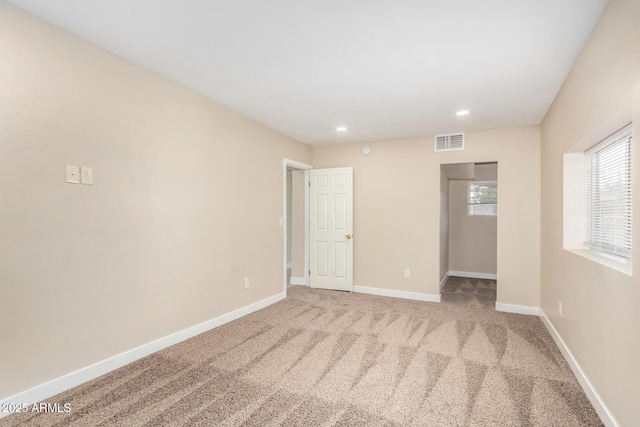 unfurnished bedroom with a walk in closet and carpet