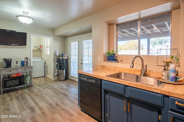 kitchen featuring blue cabinets, sink, dishwasher, washer / clothes dryer, and light hardwood / wood-style floors