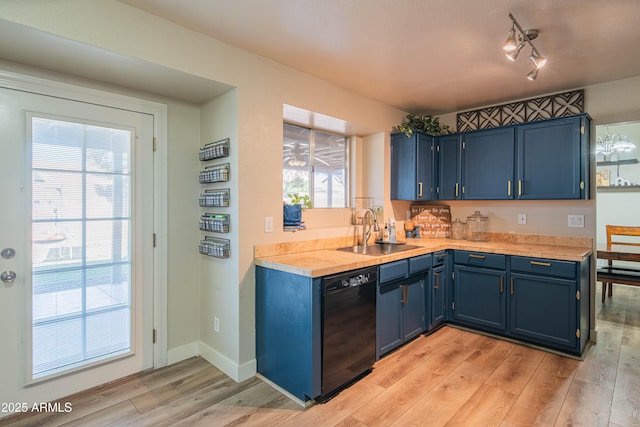 kitchen featuring dishwasher, sink, blue cabinetry, and light hardwood / wood-style flooring