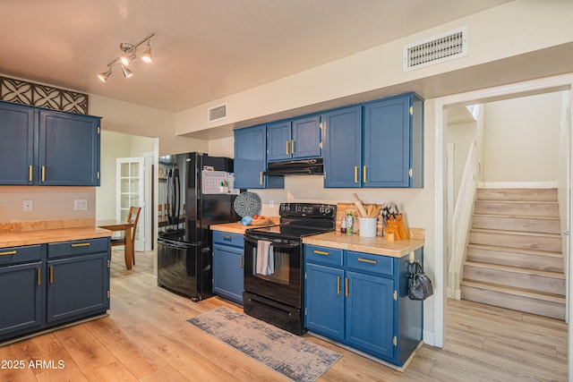 kitchen with blue cabinetry, light wood-type flooring, and black appliances