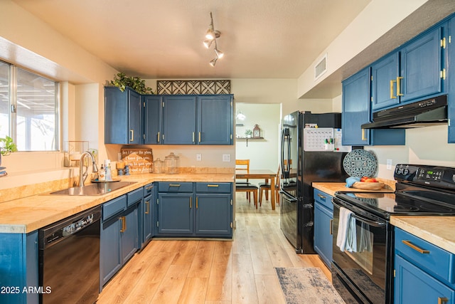 kitchen featuring blue cabinetry, light wood-type flooring, sink, and black appliances