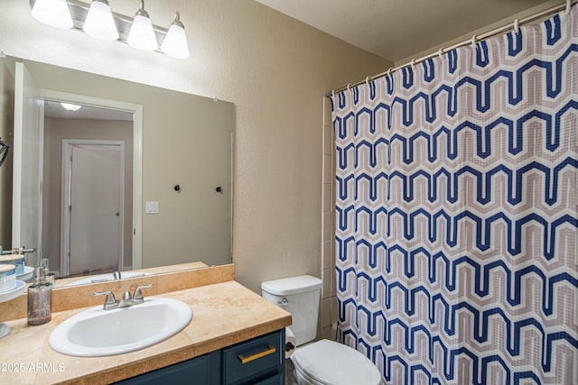 bathroom with vanity, curtained shower, and toilet