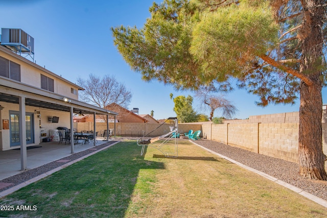 view of yard featuring a playground, central AC unit, and a patio area