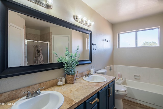 full bathroom with vanity, hardwood / wood-style floors, independent shower and bath, and toilet