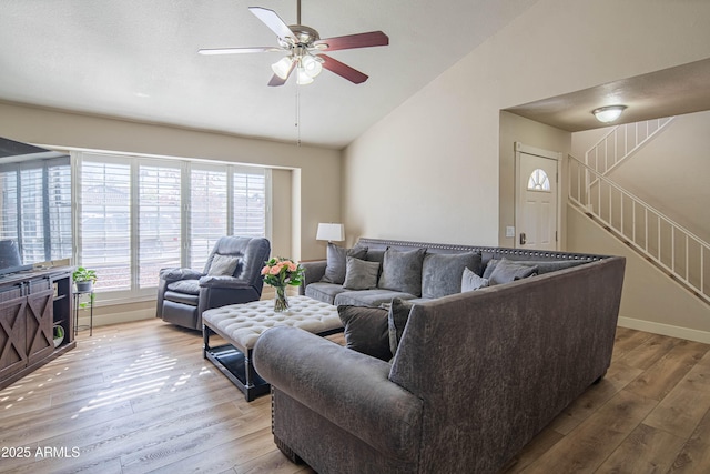 living room featuring vaulted ceiling, hardwood / wood-style floors, and ceiling fan