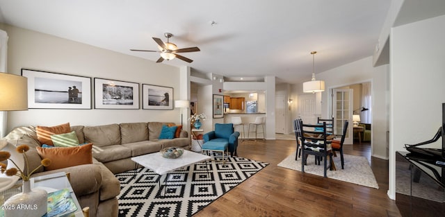 living room with dark hardwood / wood-style flooring and ceiling fan