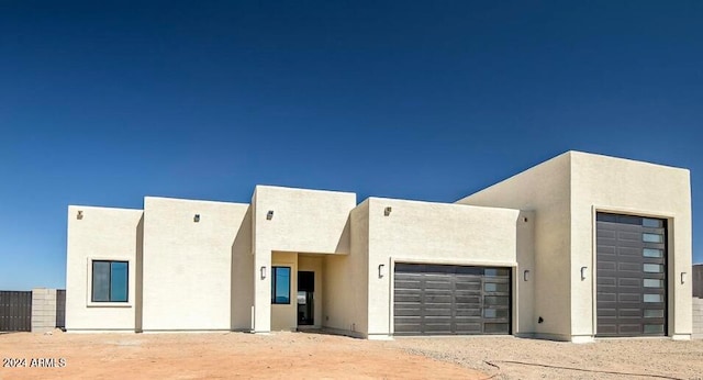 view of front of house featuring an attached garage and stucco siding