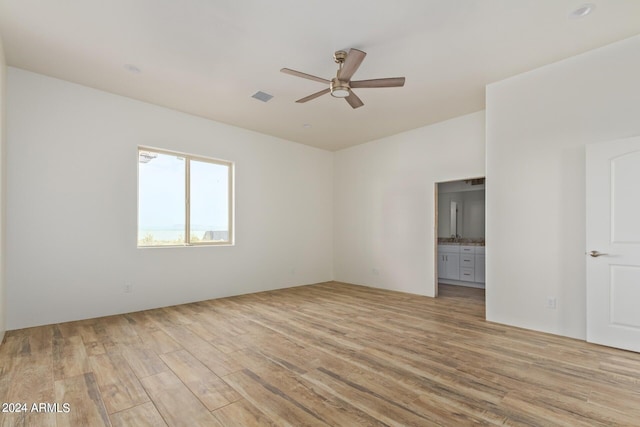 unfurnished room with ceiling fan, visible vents, and light wood-style floors