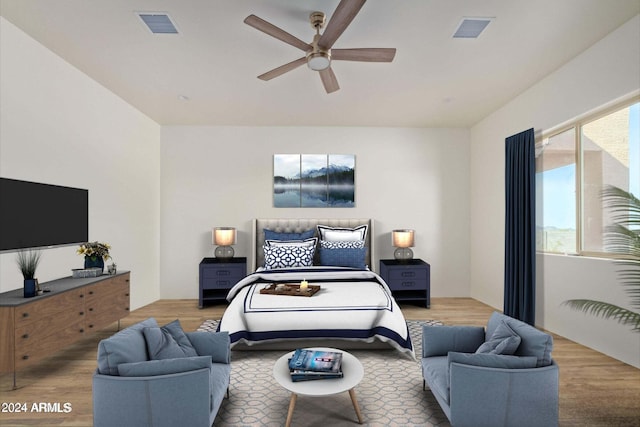 bedroom with multiple windows, wood finished floors, and visible vents