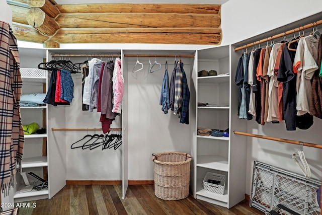 walk in closet featuring dark wood-type flooring