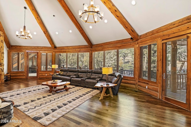 living room featuring high vaulted ceiling, dark wood-type flooring, a chandelier, and a healthy amount of sunlight