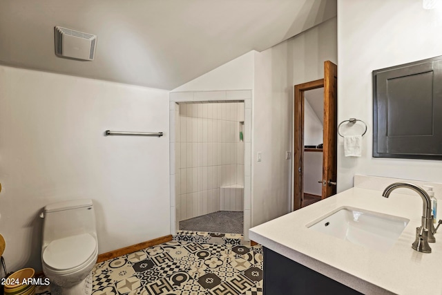 bathroom with toilet, oversized vanity, tiled shower, lofted ceiling, and tile floors