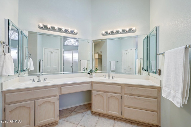 bathroom with double vanity, a sink, and tile patterned floors