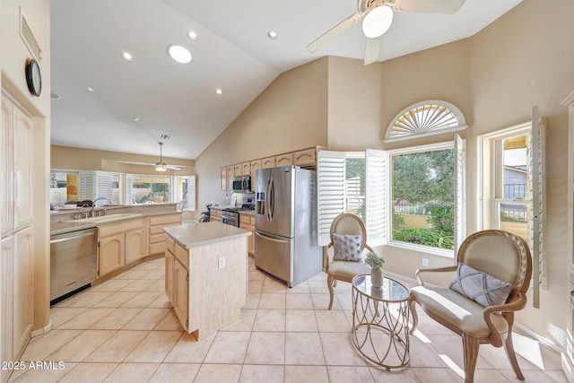 kitchen featuring a ceiling fan, light brown cabinetry, a sink, light countertops, and stainless steel appliances