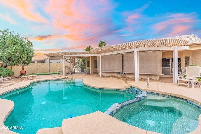 pool at dusk with a pergola, a pool with connected hot tub, fence, and a patio