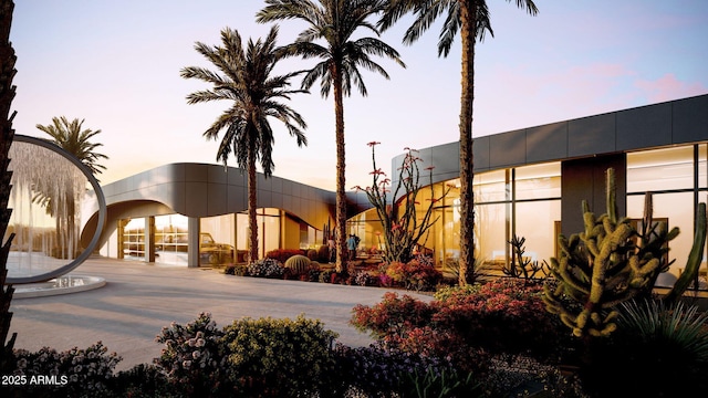 view of outdoor building at dusk