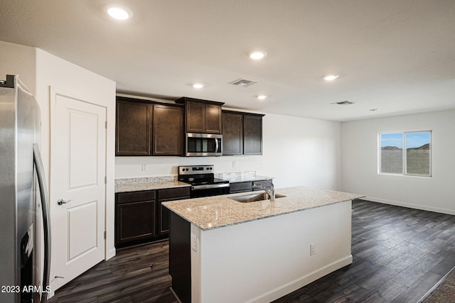 kitchen with stainless steel appliances, dark wood finished floors, visible vents, and dark brown cabinetry