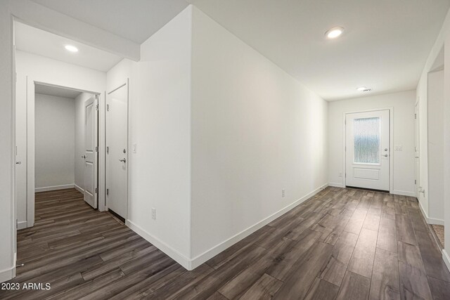 interior space with dark wood-style floors, recessed lighting, and baseboards