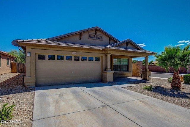 3221 W Alta Vista Rd, Phoenix, AZ 85041 - view of front of home with concrete driveway, an attached garage, fence, a tiled roof, and stucco siding
