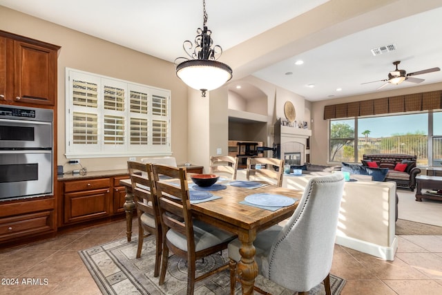 dining area featuring light tile patterned floors, a ceiling fan, visible vents, recessed lighting, and a glass covered fireplace