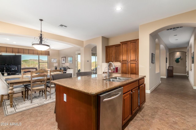 kitchen with a sink, visible vents, arched walkways, and stainless steel dishwasher