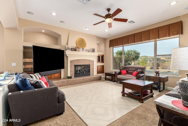 living room with a tiled fireplace, visible vents, recessed lighting, and a ceiling fan