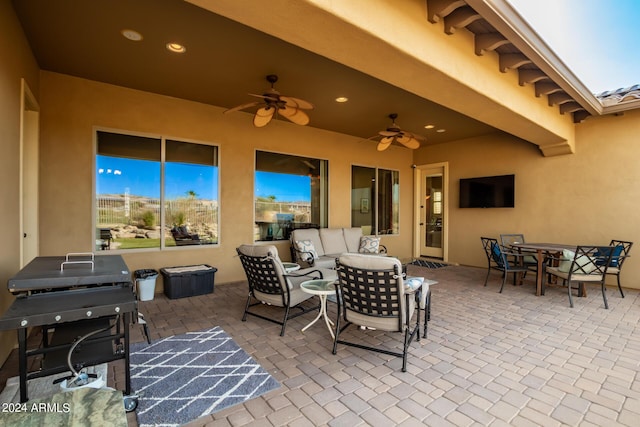 view of patio / terrace featuring outdoor dining space, area for grilling, and a ceiling fan