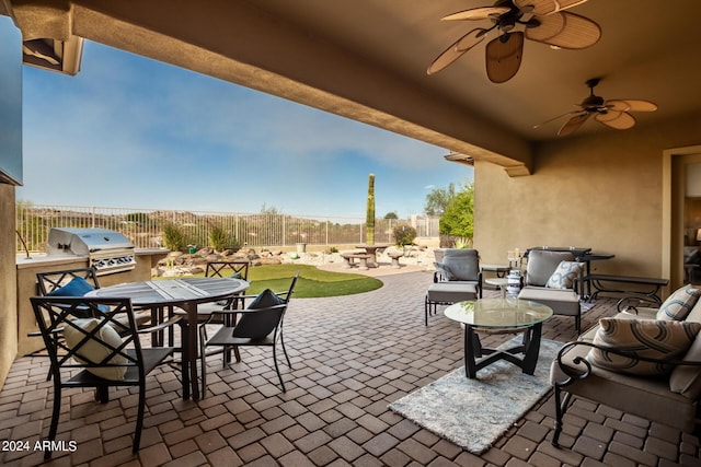 view of patio with outdoor dining space, a grill, exterior kitchen, and a fenced backyard