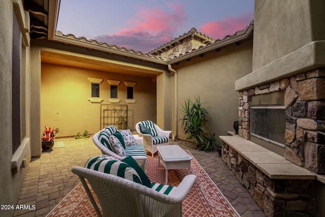 view of patio featuring an outdoor living space with a fireplace