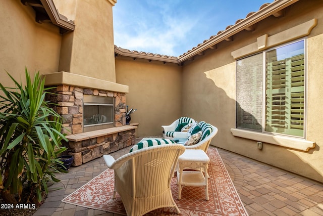 view of patio / terrace with an outdoor living space with a fireplace