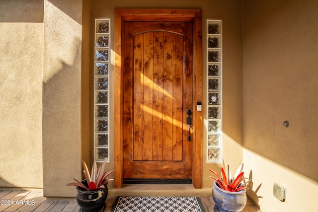 entrance to property featuring stucco siding