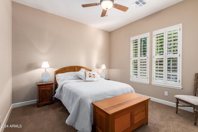 carpeted bedroom featuring visible vents, baseboards, and a ceiling fan