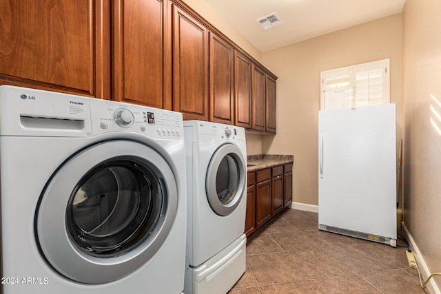 laundry area featuring visible vents, cabinet space, separate washer and dryer, tile patterned flooring, and baseboards