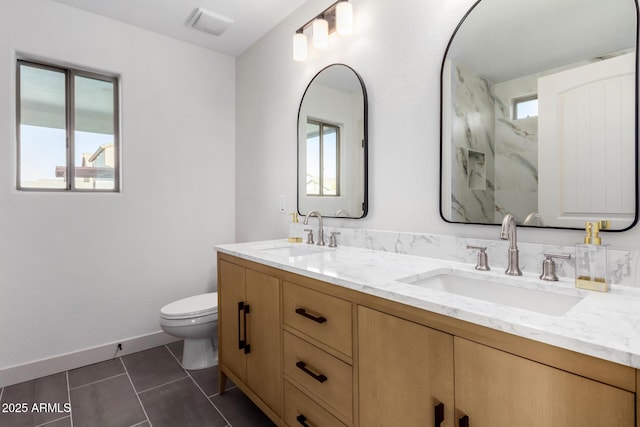 bathroom with toilet, tile patterned flooring, and vanity