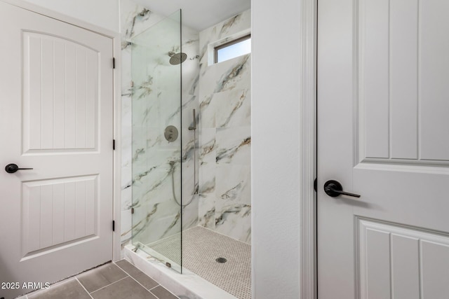 bathroom featuring tile patterned floors and tiled shower