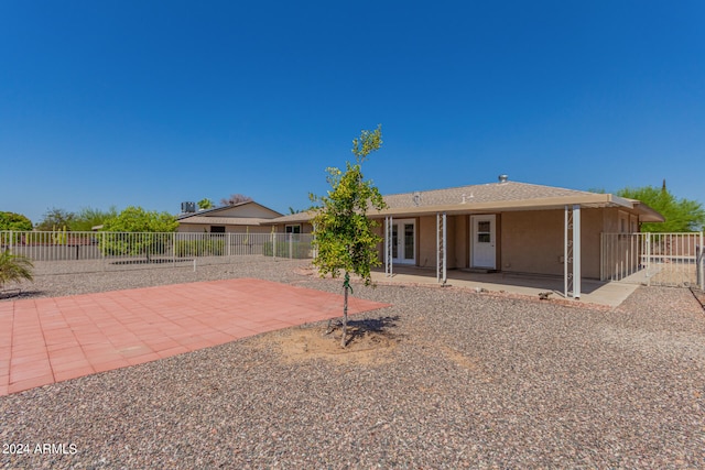 rear view of property featuring a patio area