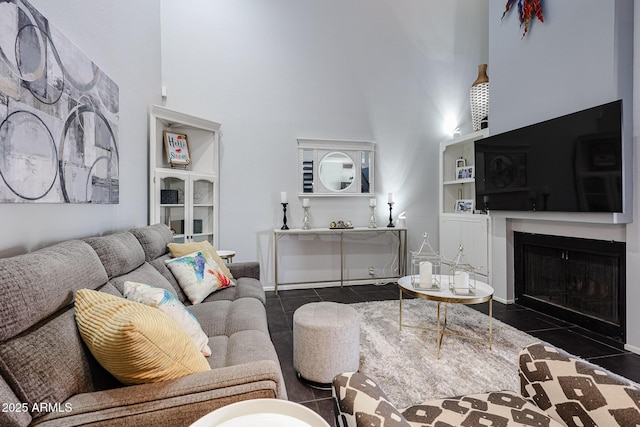 6533 N 10th Pl, Phoenix, AZ 85014 - living area with a towering ceiling, dark tile patterned flooring, and a fireplace with flush hearth