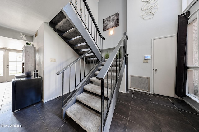 6533 N 10th Pl, Phoenix, AZ 85014 - stairway featuring tile patterned floors, baseboards, and a high ceiling