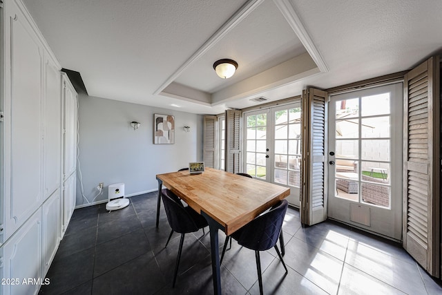 6533 N 10th Pl, Phoenix, AZ 85014 - tiled dining room with baseboards, a textured ceiling, and a raised ceiling