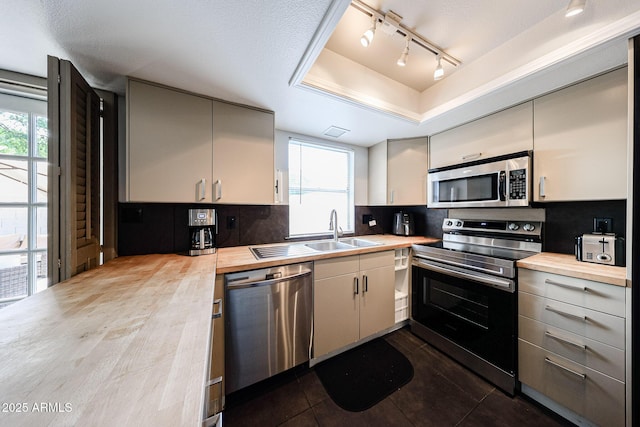 6533 N 10th Pl, Phoenix, AZ 85014 - kitchen featuring stainless steel appliances, butcher block countertops, a sink, and healthy amount of natural light