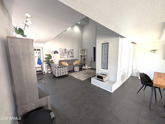 6533 N 10th Pl, Phoenix, AZ 85014 - living area featuring dark tile patterned floors and a textured ceiling