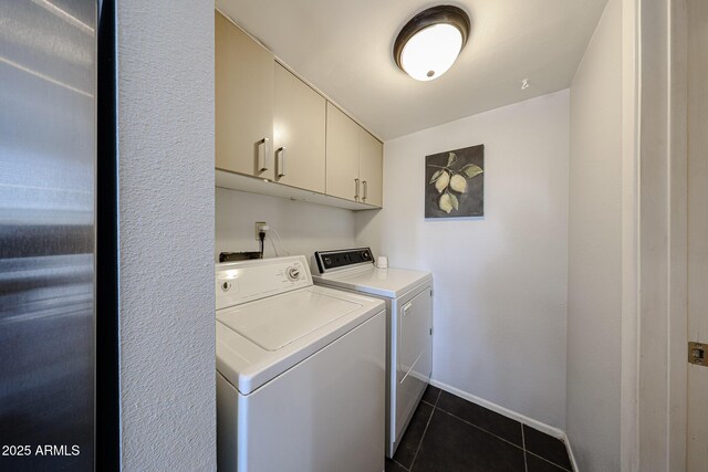 6533 N 10th Pl, Phoenix, AZ 85014 - washroom with cabinet space, washing machine and clothes dryer, dark tile patterned floors, and baseboards