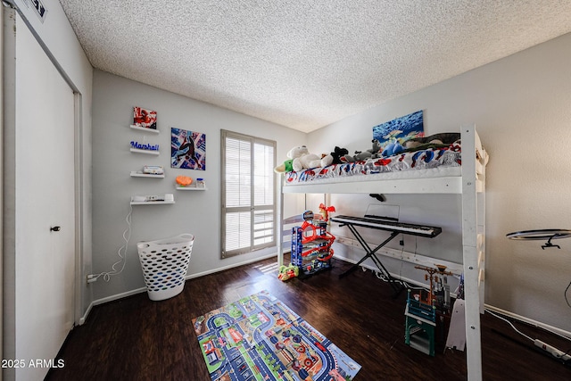 6533 N 10th Pl, Phoenix, AZ 85014 - bedroom with a textured ceiling, wood finished floors, and baseboards