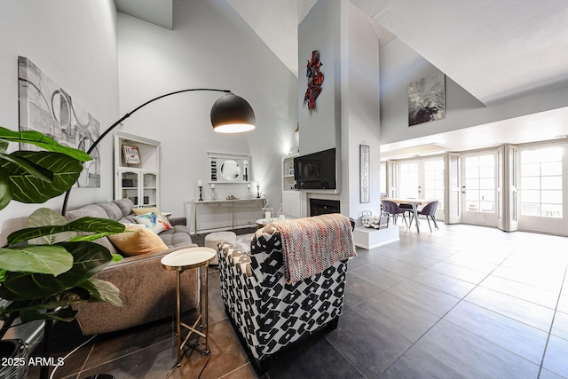 6533 N 10th Pl, Phoenix, AZ 85014 - tiled living area featuring a towering ceiling and a fireplace