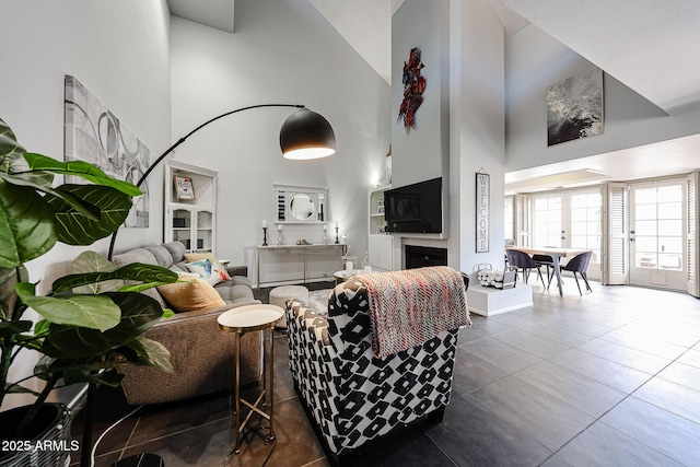 6533 N 10th Pl, Phoenix, AZ 85014 - living area featuring a high ceiling, tile patterned flooring, and a fireplace