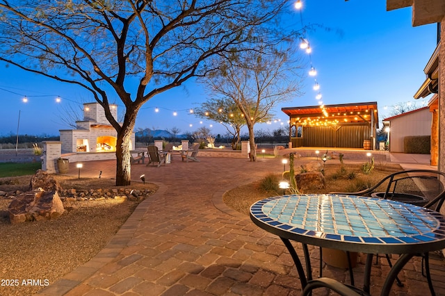 patio terrace at dusk with a fireplace