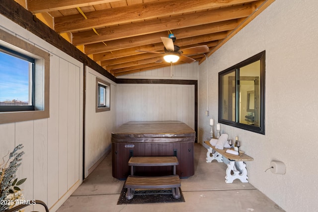 interior space with lofted ceiling and ceiling fan