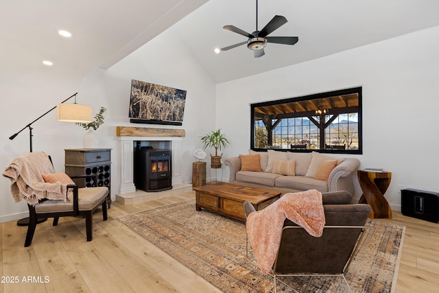 living room featuring hardwood / wood-style flooring, ceiling fan, and high vaulted ceiling