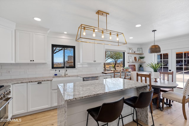 kitchen featuring white cabinetry and decorative light fixtures