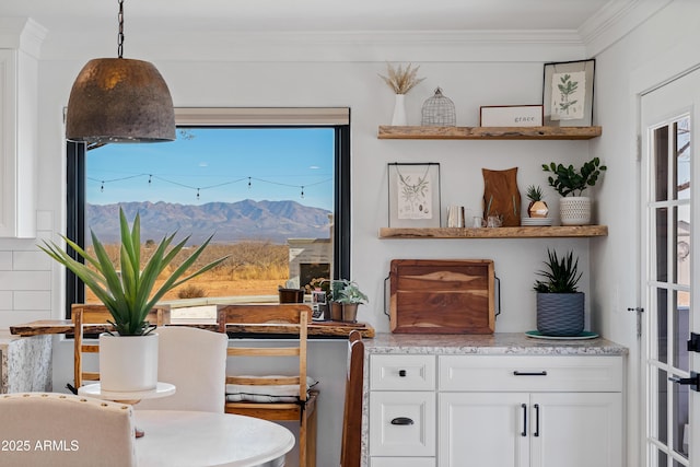 dining room with a mountain view and crown molding